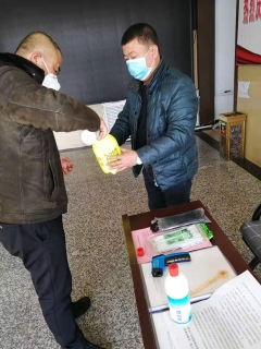 七台河公司春风矿矿党委副书记王占寒在督导检查防疫事情的同时为单位提供测温仪、消毒液、喷壶等防护用品。。。。。。。。图为王占寒（左）正与党员对办公场合举行消毒。。。。。。。。（于秀娟摄）